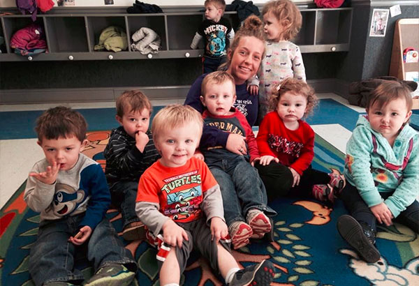 Group of toddlers and their teacher sitting on the floor at a Christian Preschool & Daycare Serving Loganville, GA