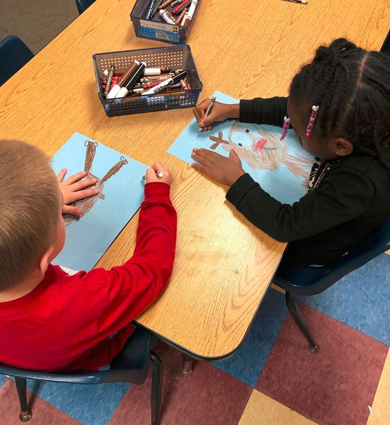 Little young preschool kids showing their drawing skills, coloring a piece of paper at a Christian Preschool & Daycare Serving Loganville, GA