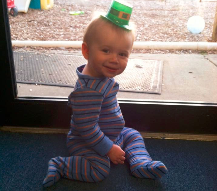 Cute little toddler boy wearing strife with a green hat on his head at a Christian Preschool & Daycare Serving Loganville, GA