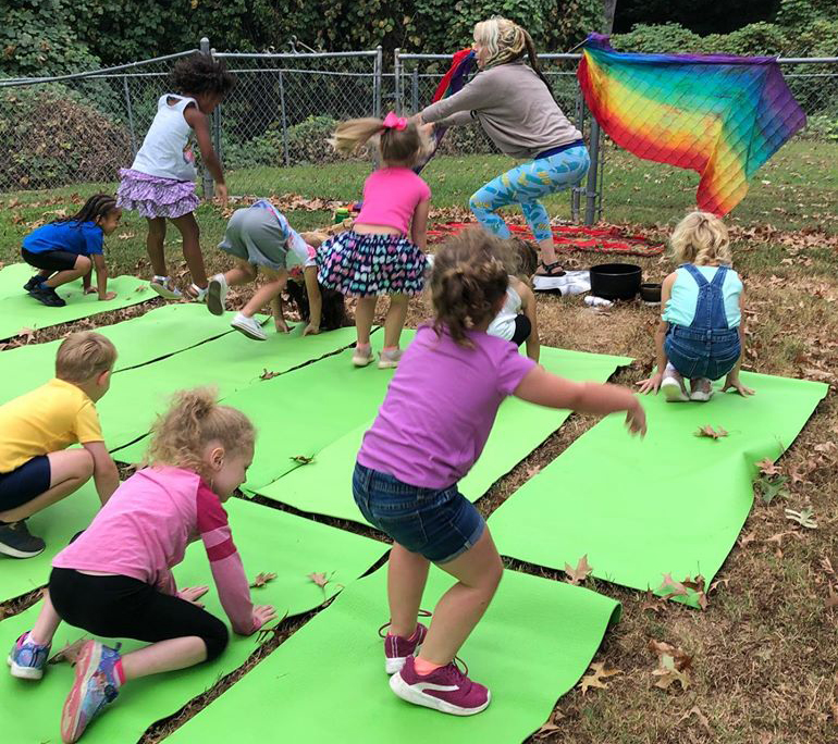 teacher and group of kids doing yoga at a Christain Preschool & Daycare Serving Loganville, GA